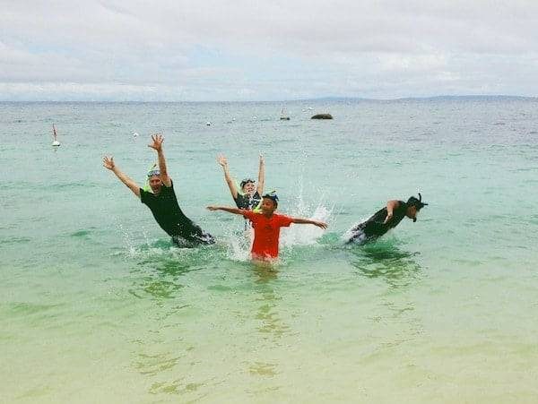People jumping out of the ocean.
