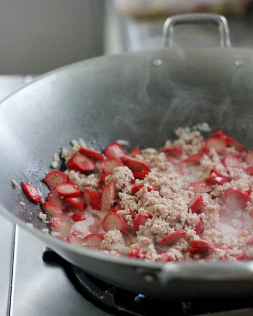 Hot dogs in a wok.