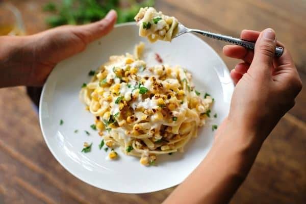 Chipotle sweet corn fettuccine on a white plate.