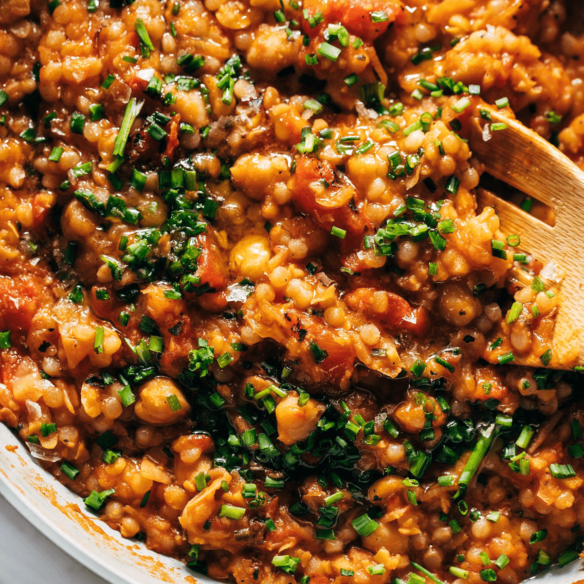 Tomato and pear couscous in a skillet.