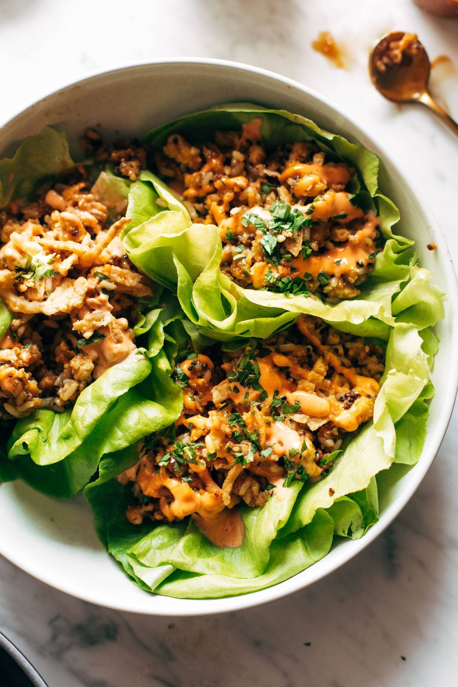Tofu and brown rice lettuce wraps with peanut sauce.