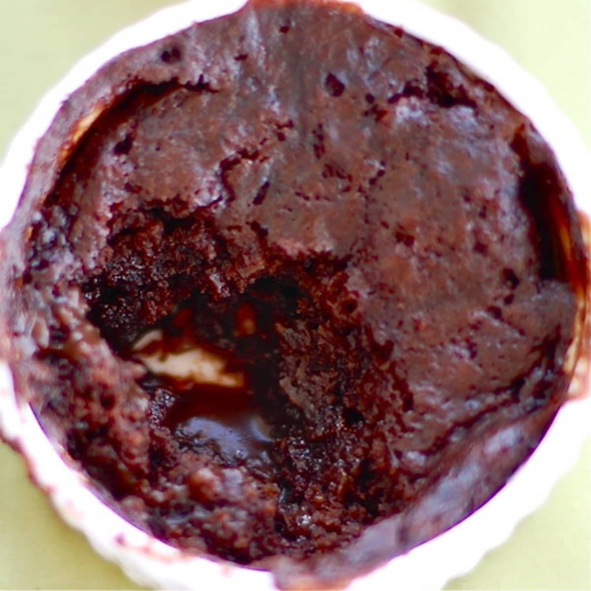 Molten Chocolate cake in a dish with oozing chocolate sauce.